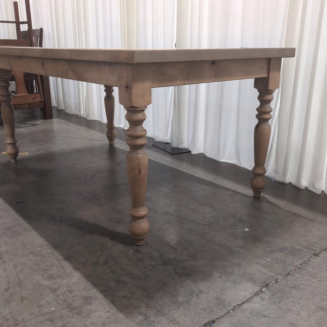 Handmade farmhouse dining table by James + James in solid knotty alder, finished in their light Harvest Wheat stain. Built...