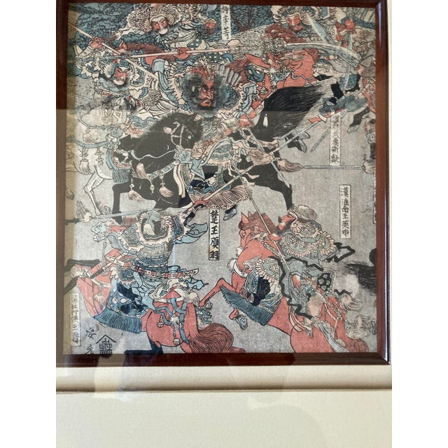 From family in Japan , this framed artwork is a Japanese ukiyo-e woodblock print depicting a chaotic samurai battle scene....