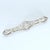 This elongated brooch features intricate filigree work with three prominent diamonds set along its length. The central...