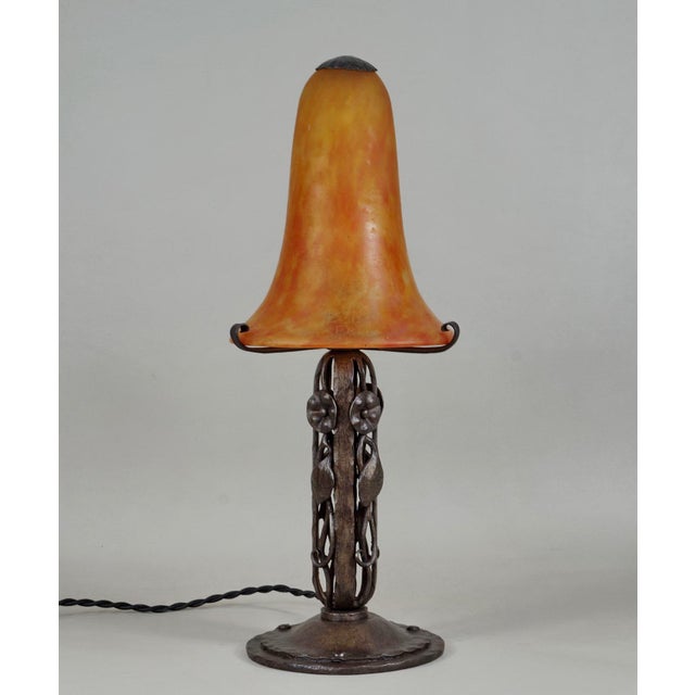 Daum A wonderful 1925-30 French art deco lamp in wrought iron of excellent quality. The forged base holds a large colored...