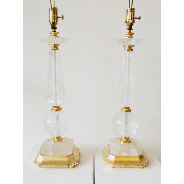 A fine pair of tall Hollywood Regency style geometric rock crystal table lamps, featuring an Obelisk and sphere column...