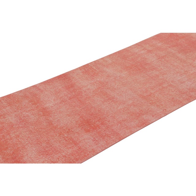 This vintage runner rug is a 3x10 Turkish distressed piece, made with hand-knotted wool circa mid-20th century. It is an...