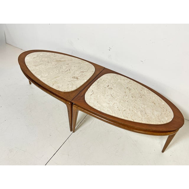 An American surfboard coffee table in walnut with Italian marble inserts, consisting of two identical wedge shaped...