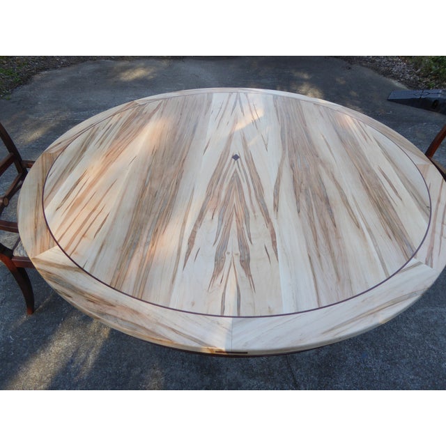 A bespoke dining tbl. in ambrosia maple & walnut. Richly book matching top w/h walnut trim. Natures art in motion w/h...