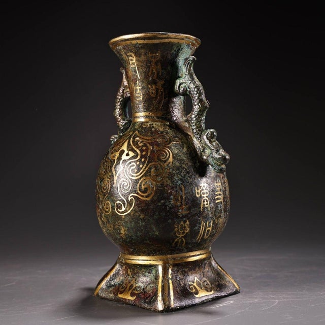 Magnificent archaic-style bronze vase fitted with a pair of sculpted dragon-head handles. The surface is beautifully...