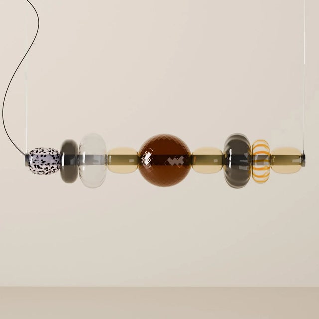Handcrafted on the island of Murano, Italy, the Playground chandelier by Oggetti is composed of nine individual mouth-...