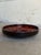 Vintage 1960s Mid-Century Modern ceramic plate features a striking, high-contrast abstract visual design. The interior...