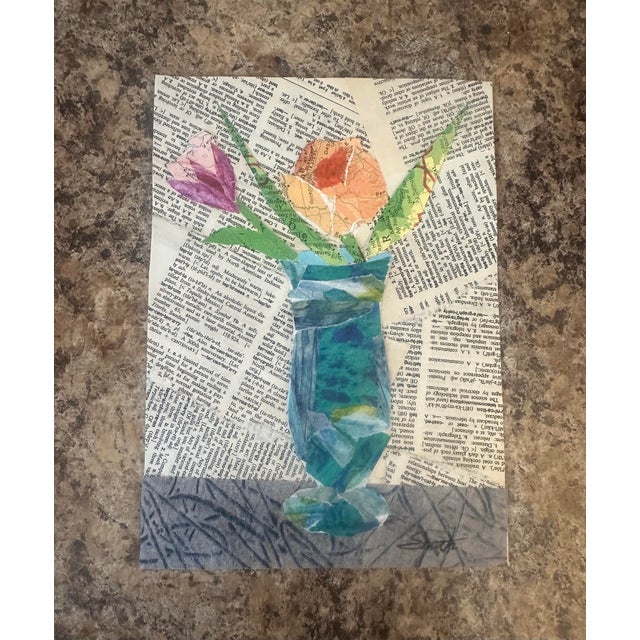 A charming mixed-media floral collage set against vintage book pages, this artwork blends delicate color with nostalgic...