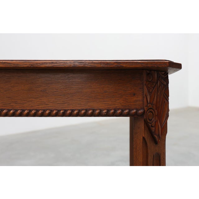 Elegant French Art Deco side table dating from the 1920s, crafted in solid wood with refined architectural lines and...