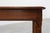 Elegant French Art Deco side table dating from the 1920s, crafted in solid wood with refined architectural lines and...