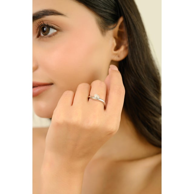 This elegant solitaire wave ring feature 1 heart shaped diamond totaling 0.51 carats, set in 14k white gold. The diamond...