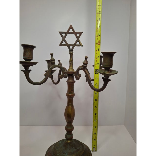 A defining artifact of 19th-century Eastern European metalwork, this monumental Shabbat candelabrum represents the...