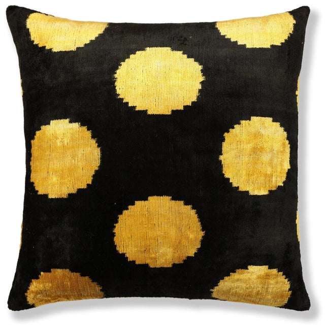 "This luxurious 20x20 inch silk velvet pillow features a bold black ground accented with luminous golden circular motifs,...