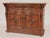 Baroque style oak sideboard, circa 1910. With a rectangular top with carved front and side edges, the frieze with two...