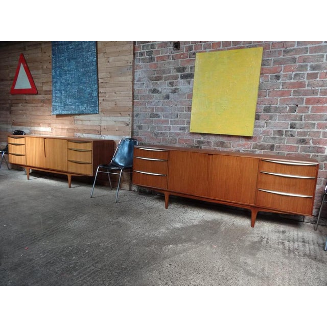 Most sought after Vintage 1960s Mcintosh sideboard by Tom Robertson. It has three drawers with brass pull handles,...