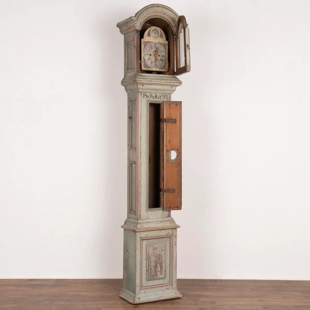 Hand painted grandfather clock with exceptional original soft blue painted finish accented in red trim. Panel details,...
