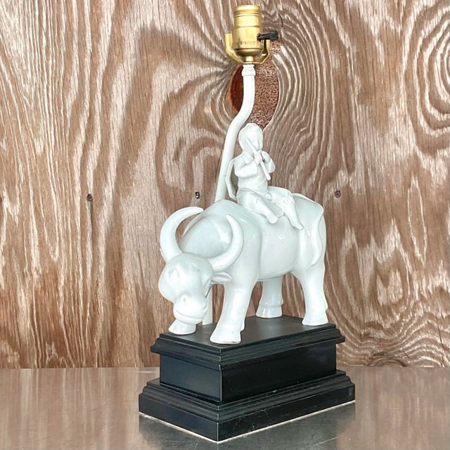Fabulous vintage Blanc De Chine table lamp. A beautiful white glazed ceramic on a black wooden plinth. A small boy with...