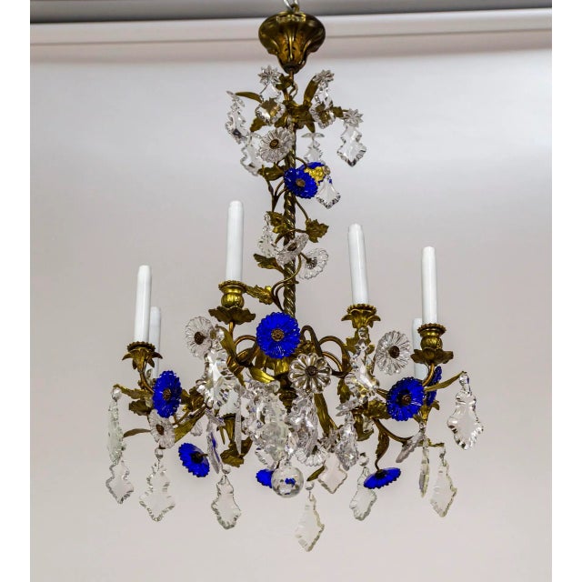 An Art Nouveau, 8-light chandelier with vibrant, deep blue molded crystal flowers and clear crystals in varying shapes....