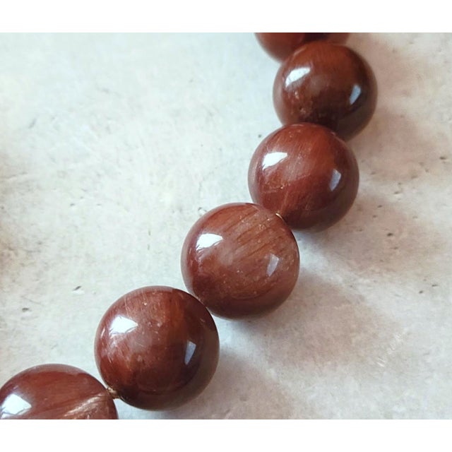 The length of the necklace is 17.5 inches (44.5 cm). The smooth, round beads are 17-18 mm in size. Bead knotting is...
