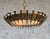 This amazing Spanish 1960s brutalist gilt metal ceiling fixture features a curved circular frame with evenly spaced nails...