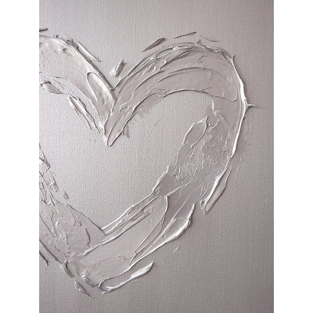 This metallic silver heart is a wonderful, fun piece for any space! It measures 12"X12". *Please note, colors may vary per...