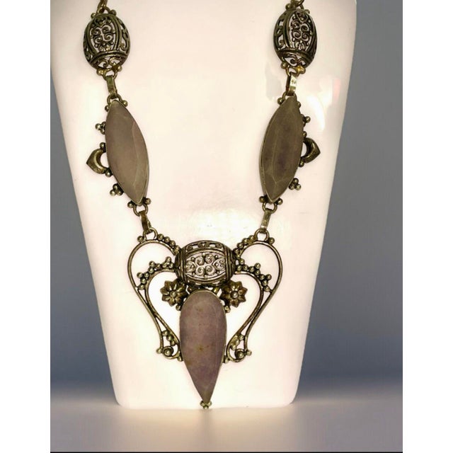 The necklace is composed of Iolite Sunstone set in ornate sterling silver filigree. Iolite Sunstone is a gemstone with the...