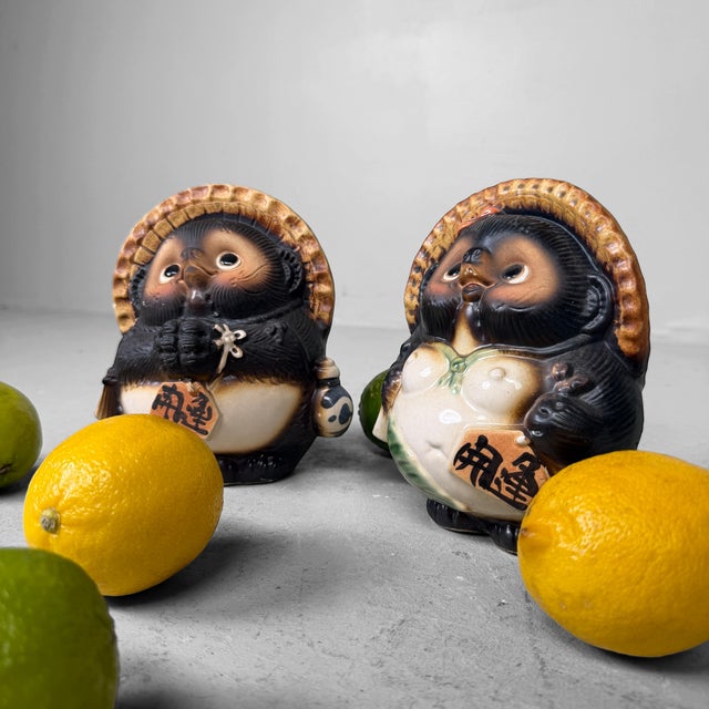 Charming pair of vintage Japanese tanuki, made in glazed ceramic and most likely dating from the 1960s–1970s. Dimensions:...