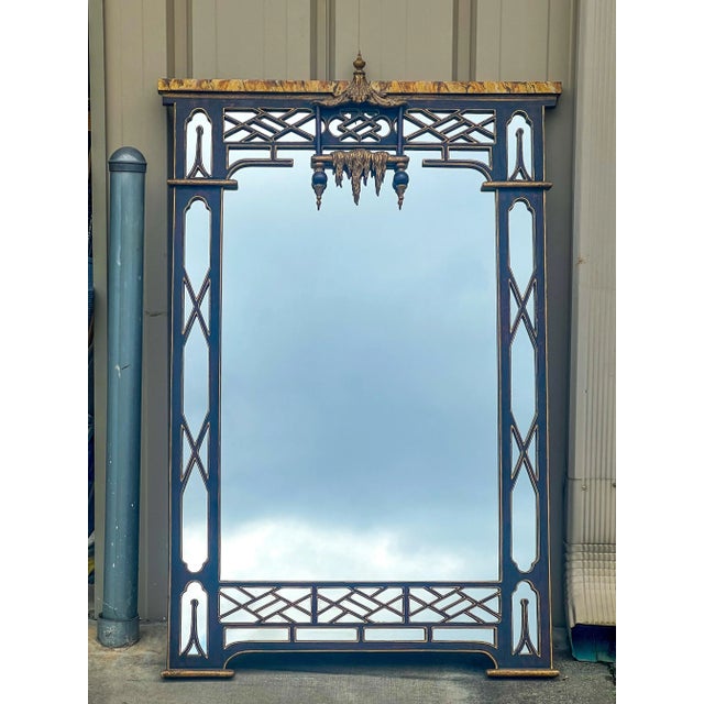This is a Chinese Chippendale style mirror with ornate carved fretwork and pagoda. The top has faux marble molding, and...