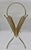 This 1960s brass-tone wire magazine rack features a deep V-shaped cradle of fanned rods, softly scalloped top rails, and a...
