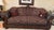 Beautiful traditional two-piece living room set featuring a full-size sofa and matching loveseat with ornate carved wood...