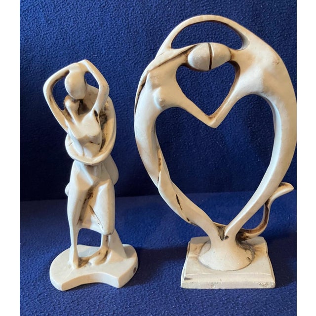 This striking pair of abstract sculptures by renowned Italian artist Amilcare Santini represents the height of Mid-Century...
