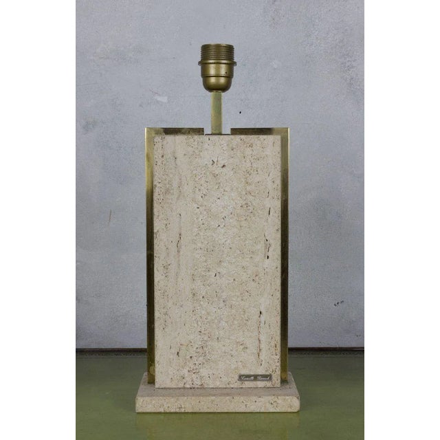 Introducing a Belgian 1970s small rectangular lamp in travertine, expertly framed in brass and signed by the renowned...