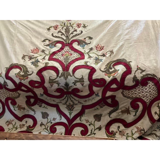 An embroidered and applique oyster moire silk coverlet or hanging, early 18th Century, the oyster ground formed from four...