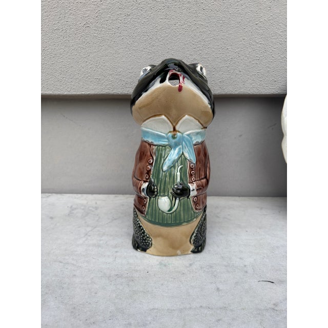 Unusual Majolica frog pitcher wearing a brown jacket signed Fives Lille, circa 1890.