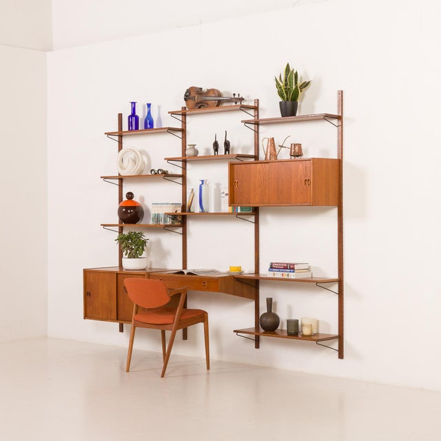 This elegant danish mid-century teak wall unit was made in the 1960s. It's a perfect example of scandinavian mid-century...