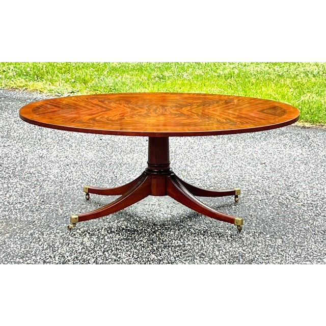 Gorgeous flame mahogany Regency/ Duncan Phyfe style oval coffee table. Simple, elegant oval top with spectacular book...