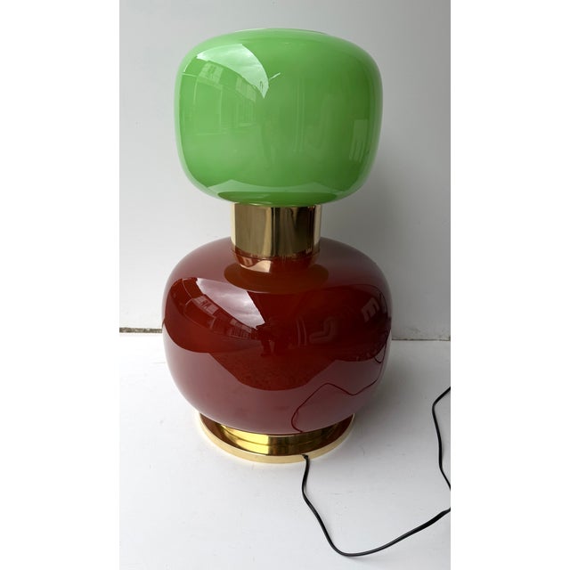 Pair of table or bedside lamps in brass, and red murano glass with green bulb globe shades. Intern lighting base....