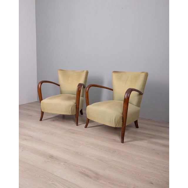 Pair of armchairs with wooden frame, green fabric upholstery and gold studs, Italian design, 1950s.