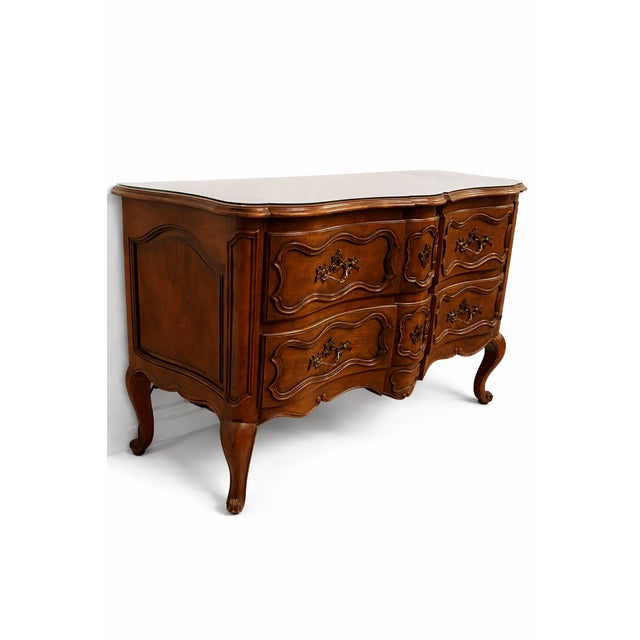 A beautiful vintage Baker Furniture commode crafted in rich walnut and designed in the classic French Provincial style....