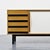 Cansado sideboard with an ash veneer body, opening with two sliding doors covered in black and white laminate and four...