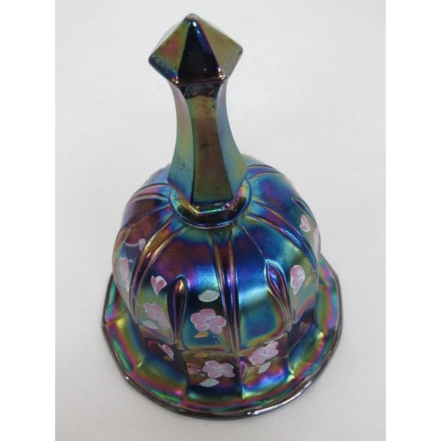 This beautiful Bell is made out of carnival glass, and is in good condition. This bell has a marvelous theme of hand...