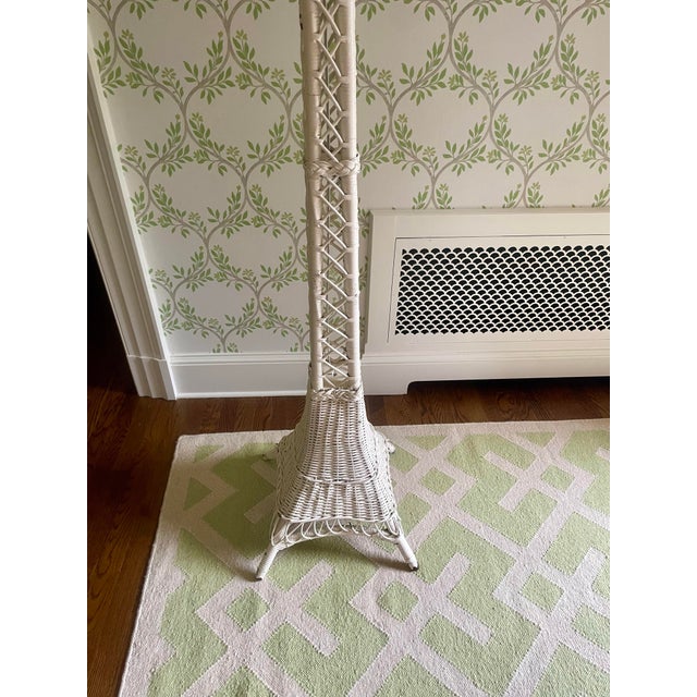 This stunning lamp has a splayed base with open wicker work. There are braided bands around the shaft and scalloped wicker...
