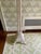 This stunning lamp has a splayed base with open wicker work. There are braided bands around the shaft and scalloped wicker...