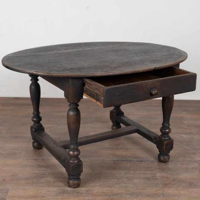 19th-century Swedish oval side table with single drawer crafted in oak with turned legs joined by a trestle base. The...