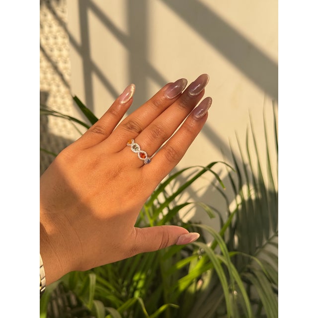 This half band ring features a 1.62 carat oval cut multi sapphire set in 14K white gold. Each sapphire measuring...