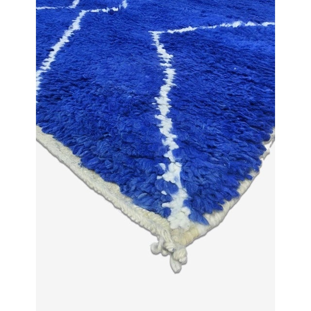 Contemporary Moroccan Rug | Handwoven Berber Wool Rug with Royal Blue Field and White Zigzag Lattice This bold...