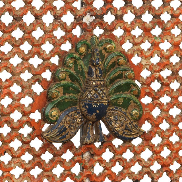 A beautifully weathered jali panel from rajasthan, combining intricate openwork carving with vibrant remnants of its...