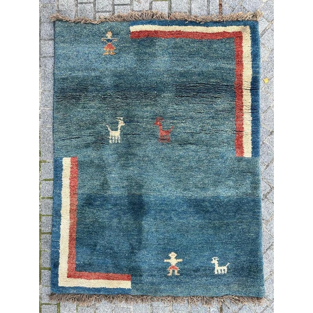 Introducing a stunning Gabbeh rug, meticulously hand-knotted in pure wool on a woolen foundation. This exquisite piece...