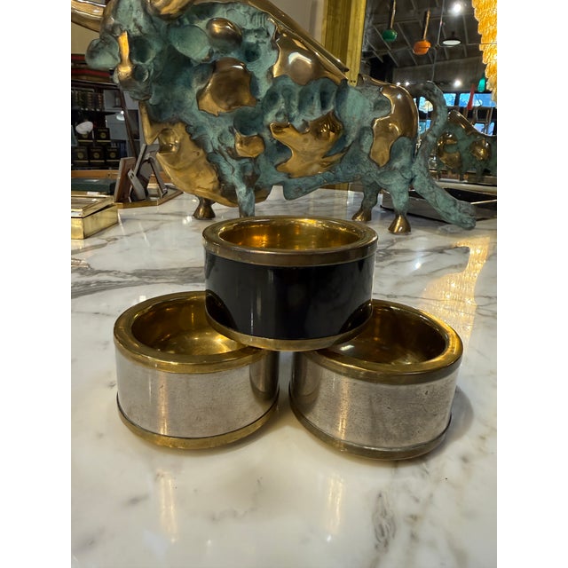A refined set of three vintage Italian salt cellars crafted in solid brass with elegant black lacquered bands. Each piece...