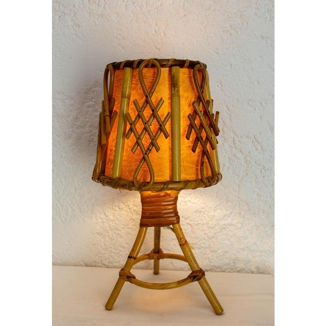 Little rattan table lamp made in France circa 1950. A great deal of care went into making this object, which is still in...